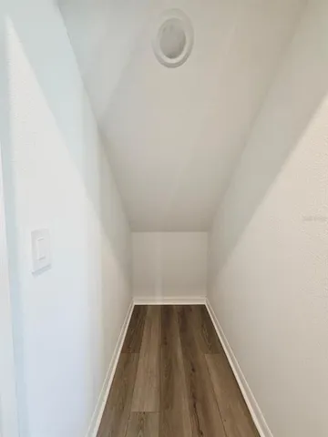 a view of an empty room and closet area