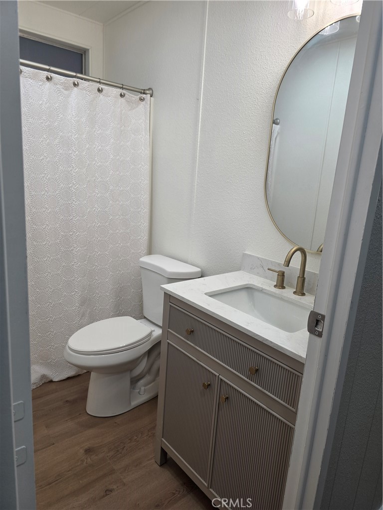 620 Lake Ridge Way, Unit 45 La Habra, CA 90631 - Photo 13 of 21 a bathroom with a sink a toilet and a mirror