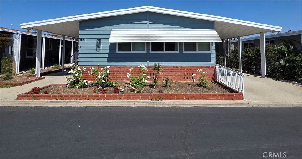 620 Lake Ridge Way, Unit 45 La Habra, CA 90631 - Photo 3 of 21 a view of a house with a small yard and potted plants
