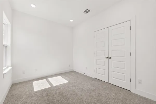 an empty room with closet area