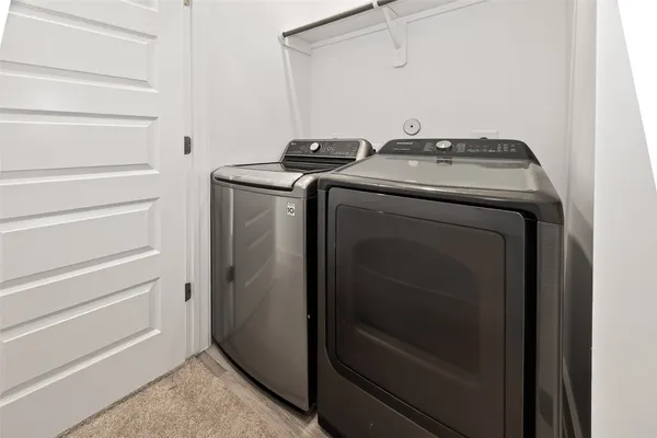 a bathroom with a toilet sink vanity tub and mirror
