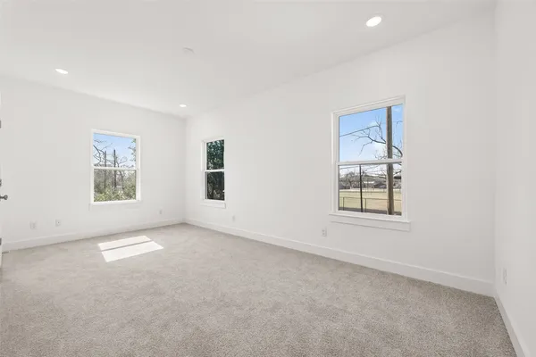 an empty room with windows and closet
