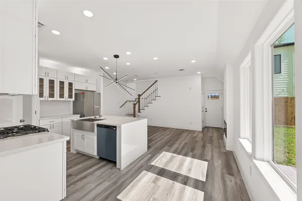 a view of kitchen with wooden floor and electronic appliances