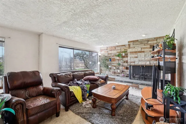 a living room with furniture and a floor to ceiling window