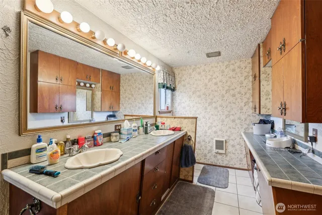 a bathroom with a double vanity sink and a mirror