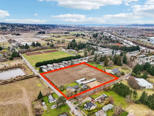 an aerial view of a tennis ground and a cars park