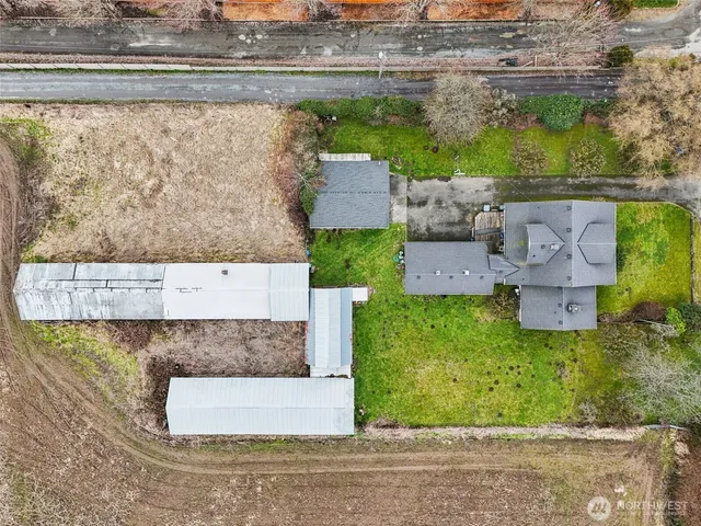 an aerial view of a house with a garden and pool