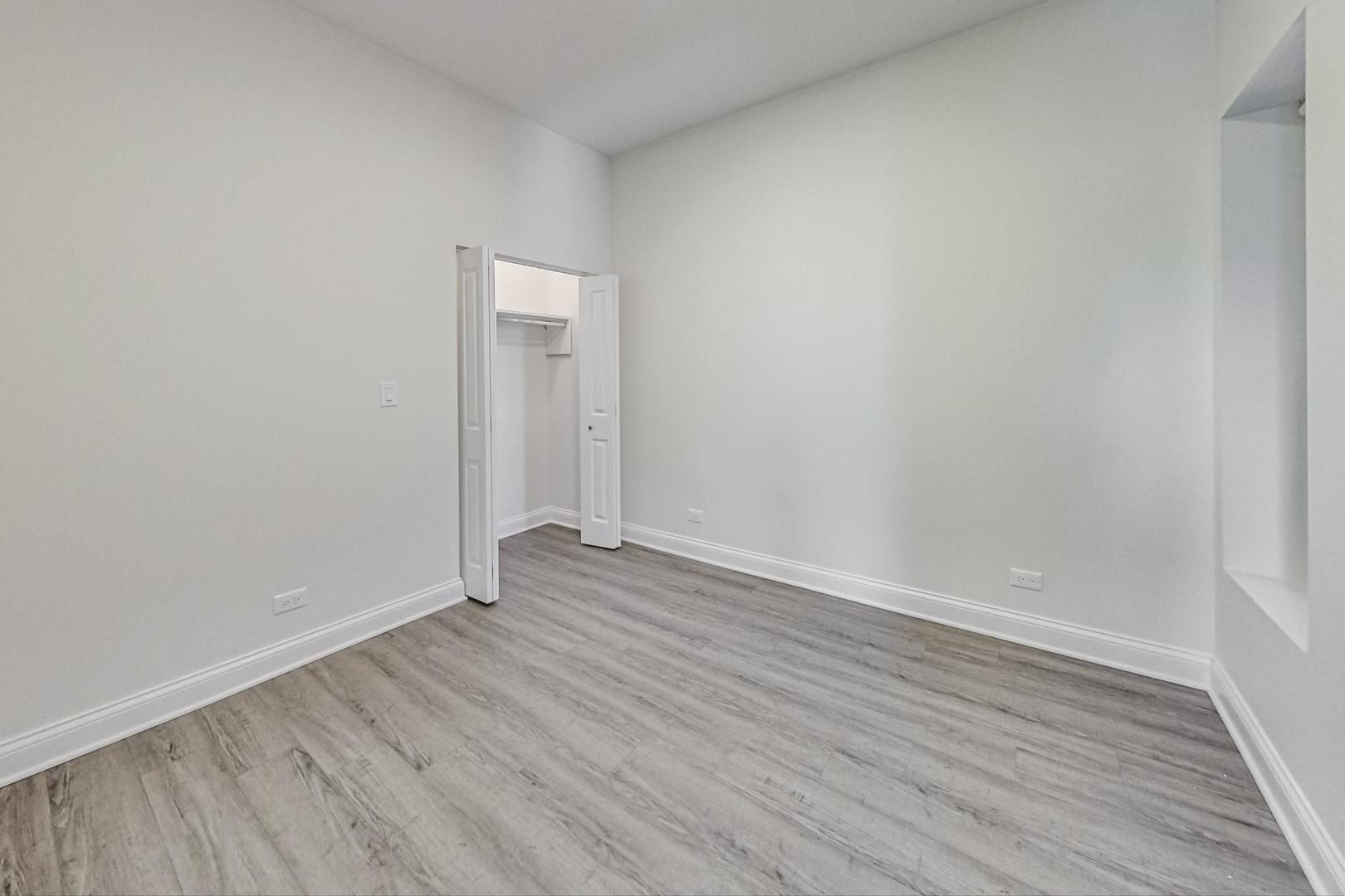 2312 West Ohio Street, Unit 2S Chicago, IL 60612 - Photo 15 of 18 a view of an empty room with wooden floor and a window