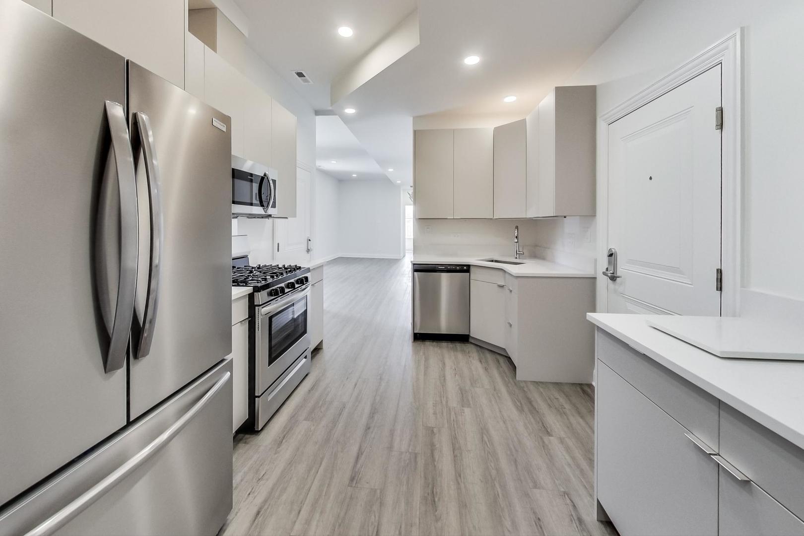 2312 West Ohio Street, Unit 2S Chicago, IL 60612 - Photo 2 of 18 a kitchen with a sink stainless steel appliances and counter space