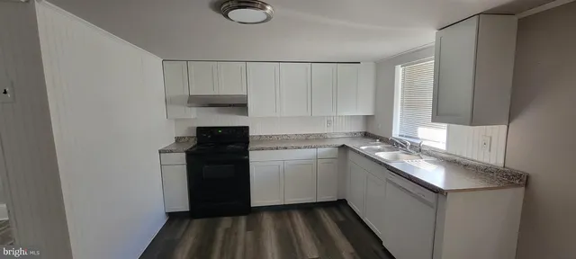 a kitchen with a sink and a stove