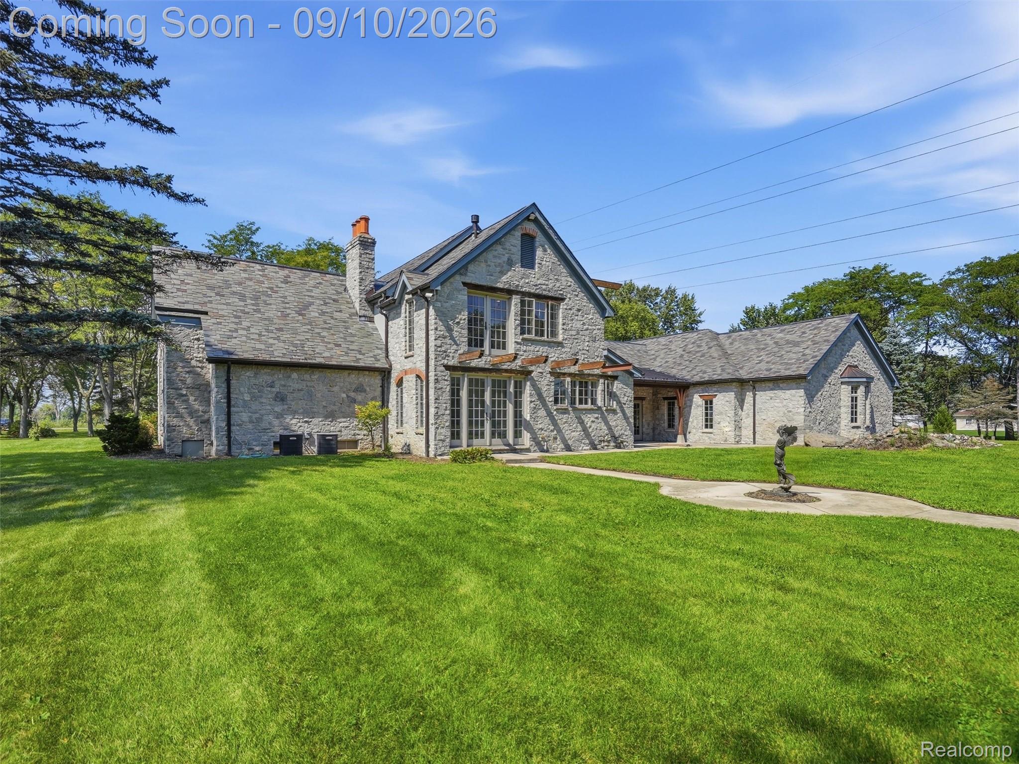 61400 Romeo Plank Road Ray, MI 48096 - Photo 11 of 99 Stone exterior with multiple gables and a prominent chimney