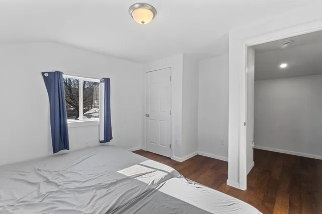 a view of a room with wooden floor and a bathroom