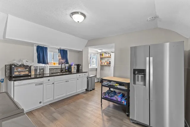 a kitchen with stainless steel appliances granite countertop a stove and a refrigerator