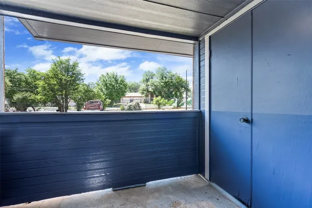 a view of house with a yard and potted plants