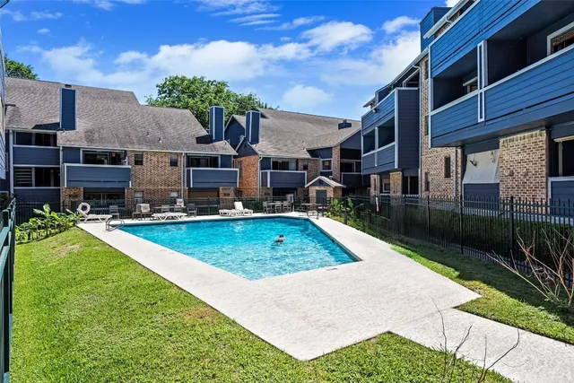 a front view of a house with a yard garden and outdoor seating