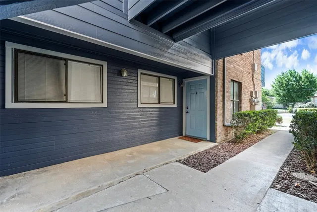 a view of a door and brick walls