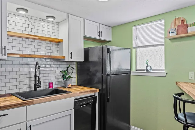 a kitchen with stainless steel appliances a refrigerator and a sink
