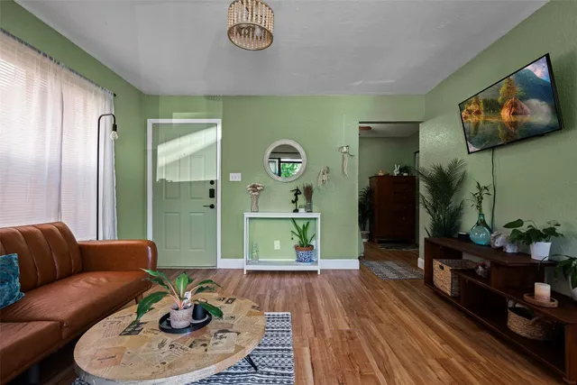 a living room with furniture and wooden floor