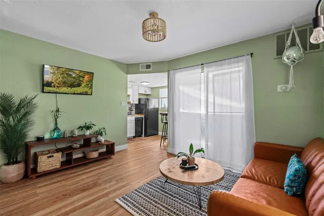 a living room with furniture and wooden floor