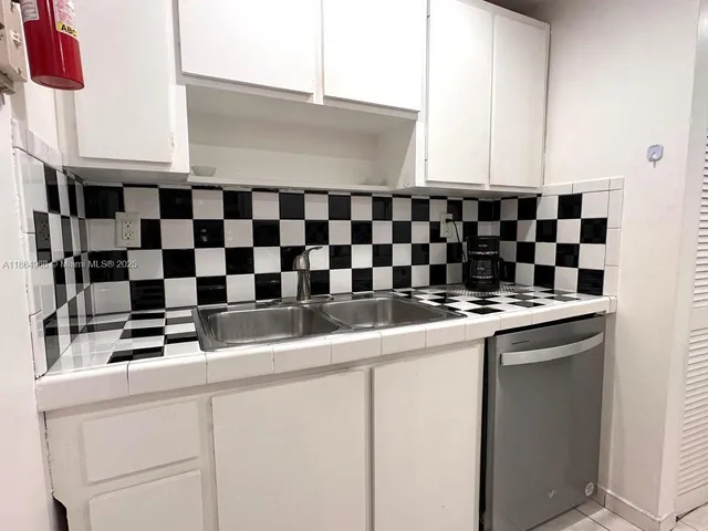 a kitchen with granite countertop a stove and a refrigerator