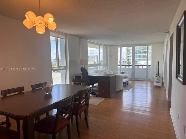 a view of a dining room with furniture wooden floor and chandelier