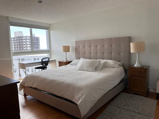 a bedroom with a bed and a table