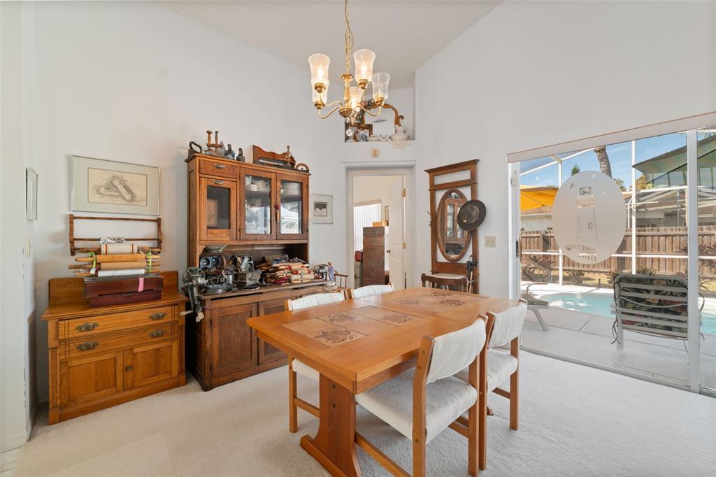 5301 El Cerro Drive New Port Richey, FL 34655 - Photo 11 of 31 a dining hall with granite countertop a stove top oven a sink a dining table and chairs