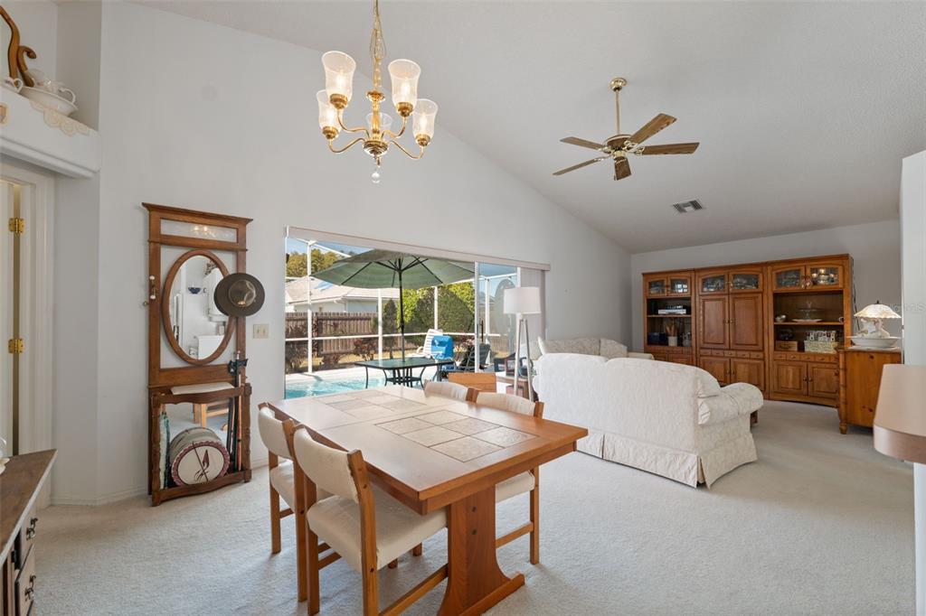 5301 El Cerro Drive New Port Richey, FL 34655 - Photo 12 of 31 a living room with dining table and a chandelier