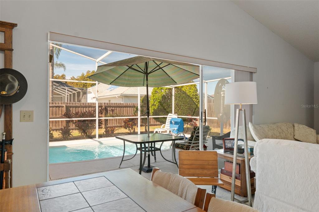 5301 El Cerro Drive New Port Richey, FL 34655 - Photo 13 of 31 a view of a dining room with furniture and chandelier
