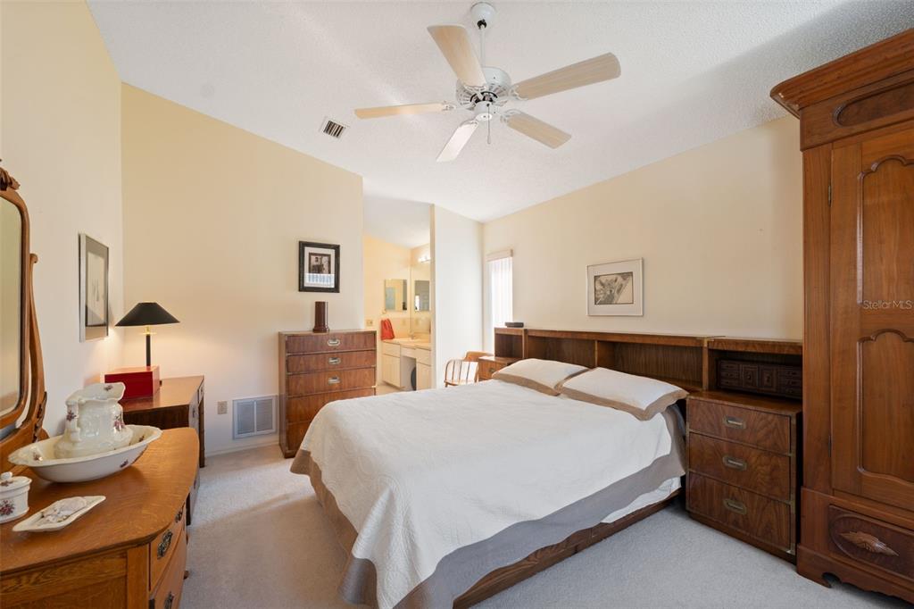 5301 El Cerro Drive New Port Richey, FL 34655 - Photo 19 of 31 a bedroom with a bed and a chandelier