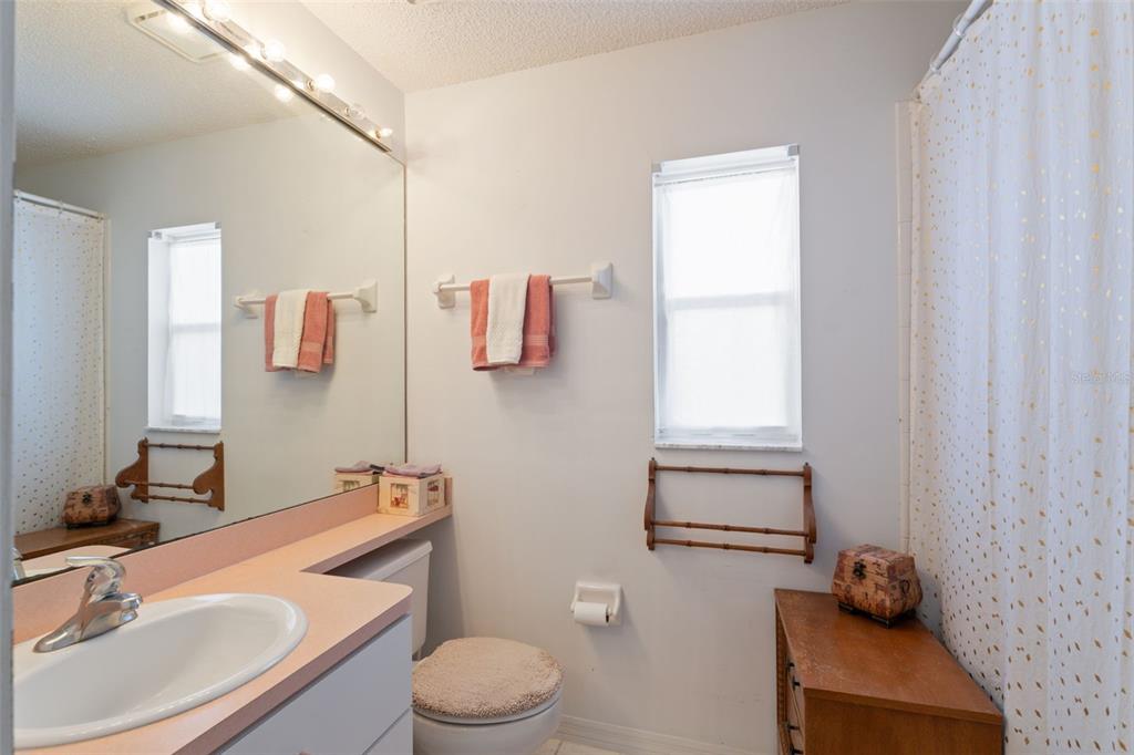 5301 El Cerro Drive New Port Richey, FL 34655 - Photo 22 of 31 a bathroom with a sink toilet a mirror and shower tub