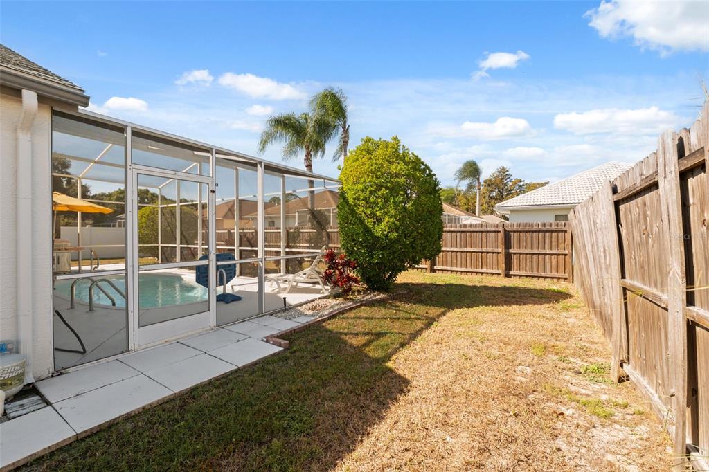 5301 El Cerro Drive New Port Richey, FL 34655 - Photo 27 of 31 a view of a porch with a floor to ceiling window and potted plants