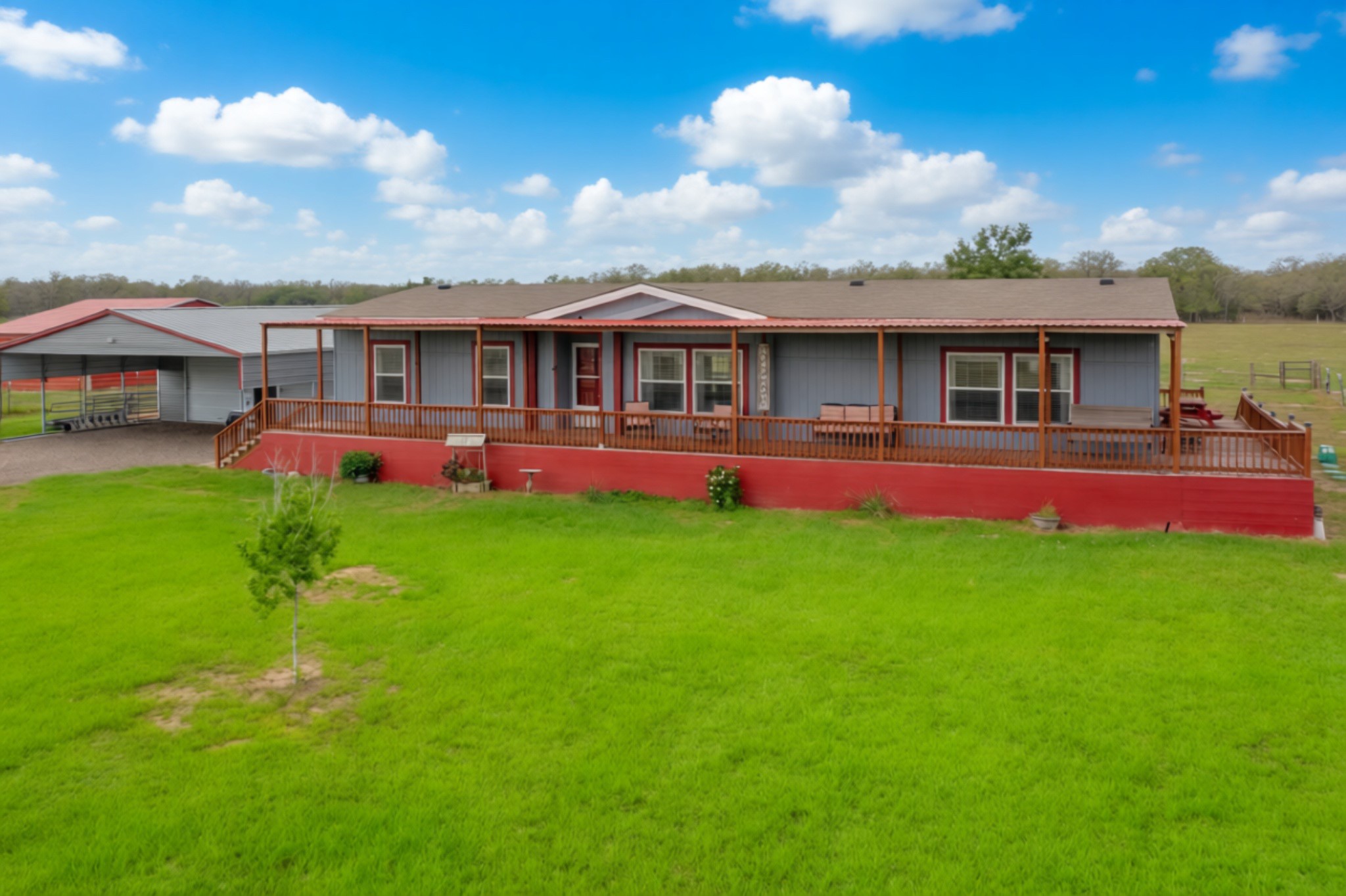Ranch-style residence featuring a full-length covered porch with wood railing