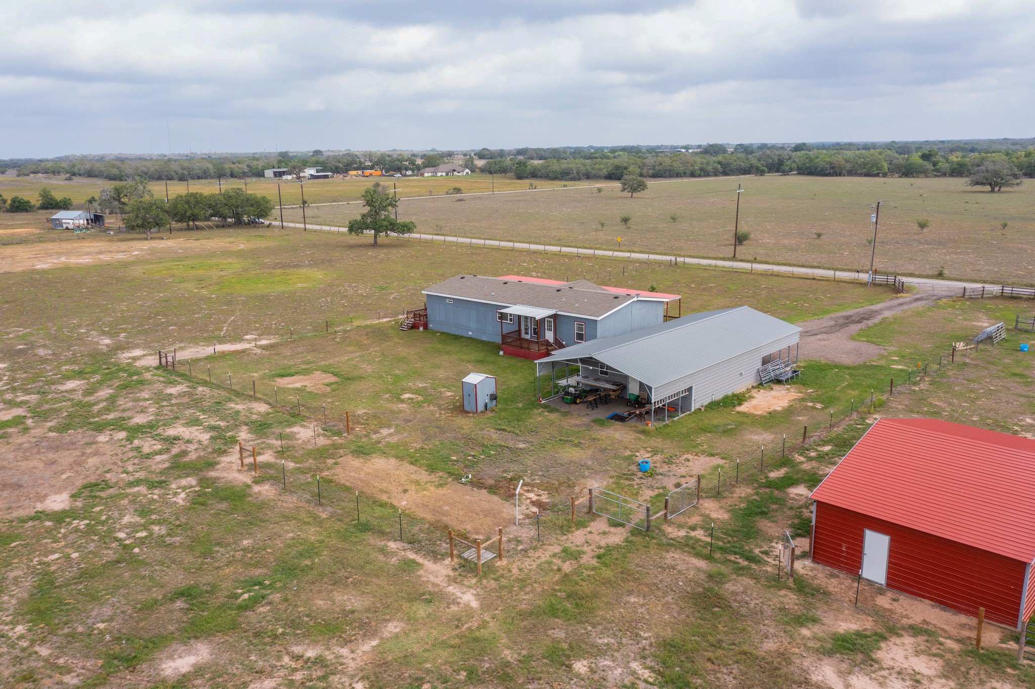 664 Garrett Road Yoakum, TX 77995 - Photo 22 of 39 Set up for tiny home in the right rear corner of the fenced yard. Also full RV connections to the right of the carport. You can see the outlines of where previous tiny home & RV sat.
