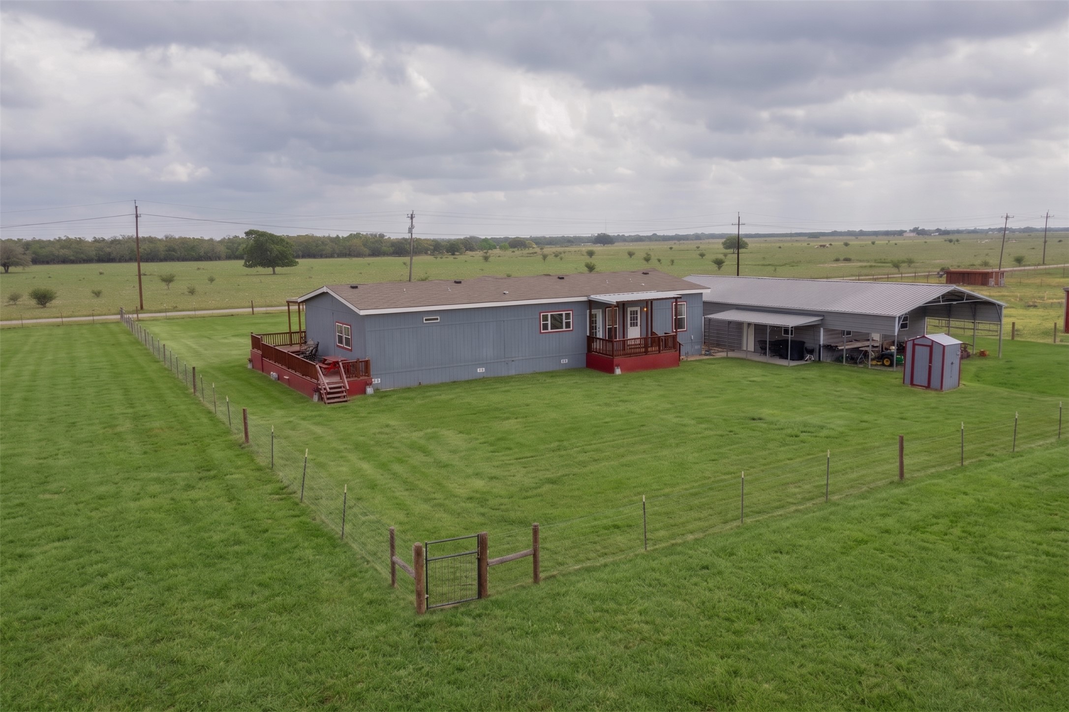 664 Garrett Road Yoakum, TX 77995 - Photo 23 of 39 Rear view of backyard area--grass virtually added