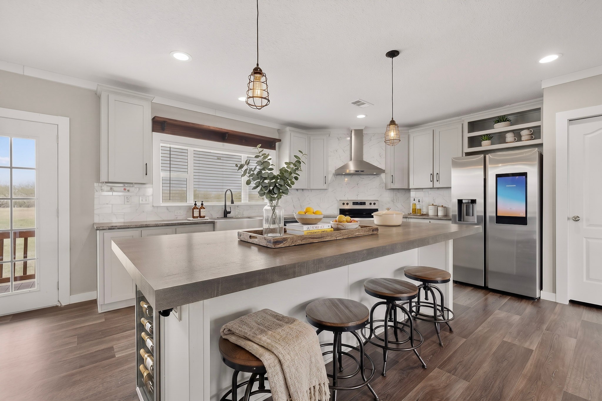 664 Garrett Road Yoakum, TX 77995 - Photo 4 of 39 Virtually Staged : Spacious kitchen featuring a large island with seating, stainless steel appliances, white cabinetry