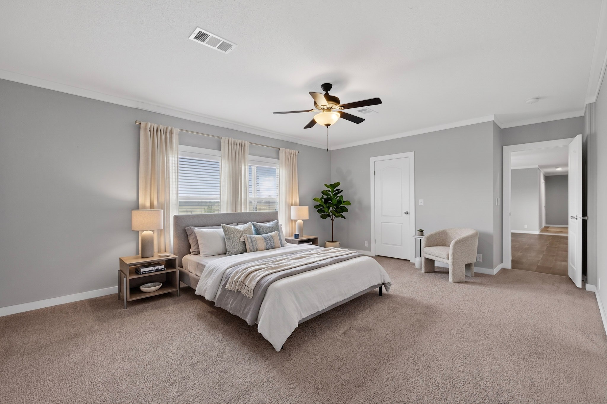 664 Garrett Road Yoakum, TX 77995 - Photo 7 of 39 Virtually Staged : Carpeted room featuring a ceiling fan with integrated lighting, multiple windows with blinds, crown molding, and a neutral color palette