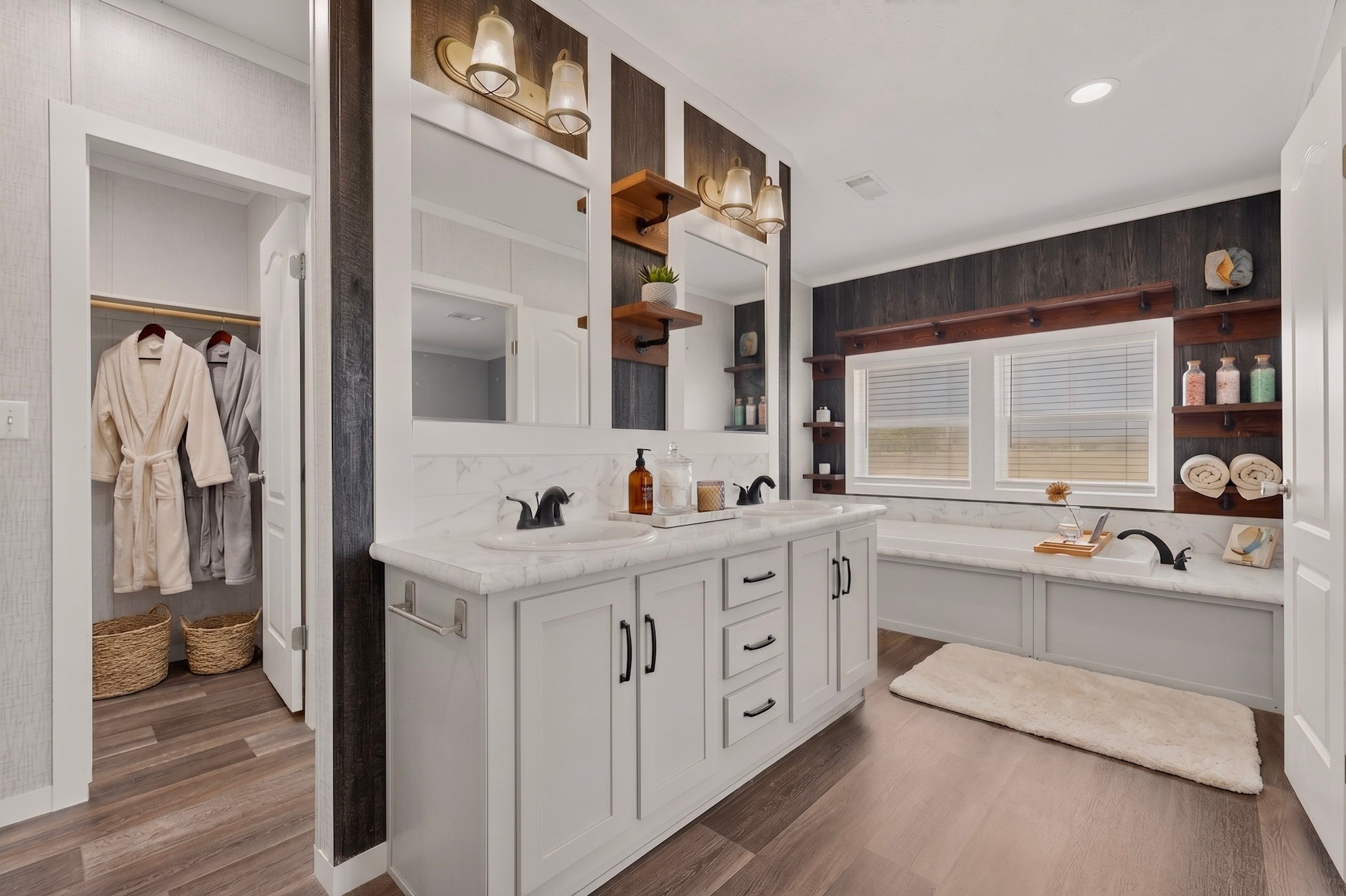 664 Garrett Road Yoakum, TX 77995 - Photo 9 of 39 Virtually Staged : Bathroom featuring a dual vanity with white cabinetry and marble-patterned countertops, a built-in soaking tub with surrounding ledge, a window with horizontal blinds, and Beauflor luxury vinyl plank flooring