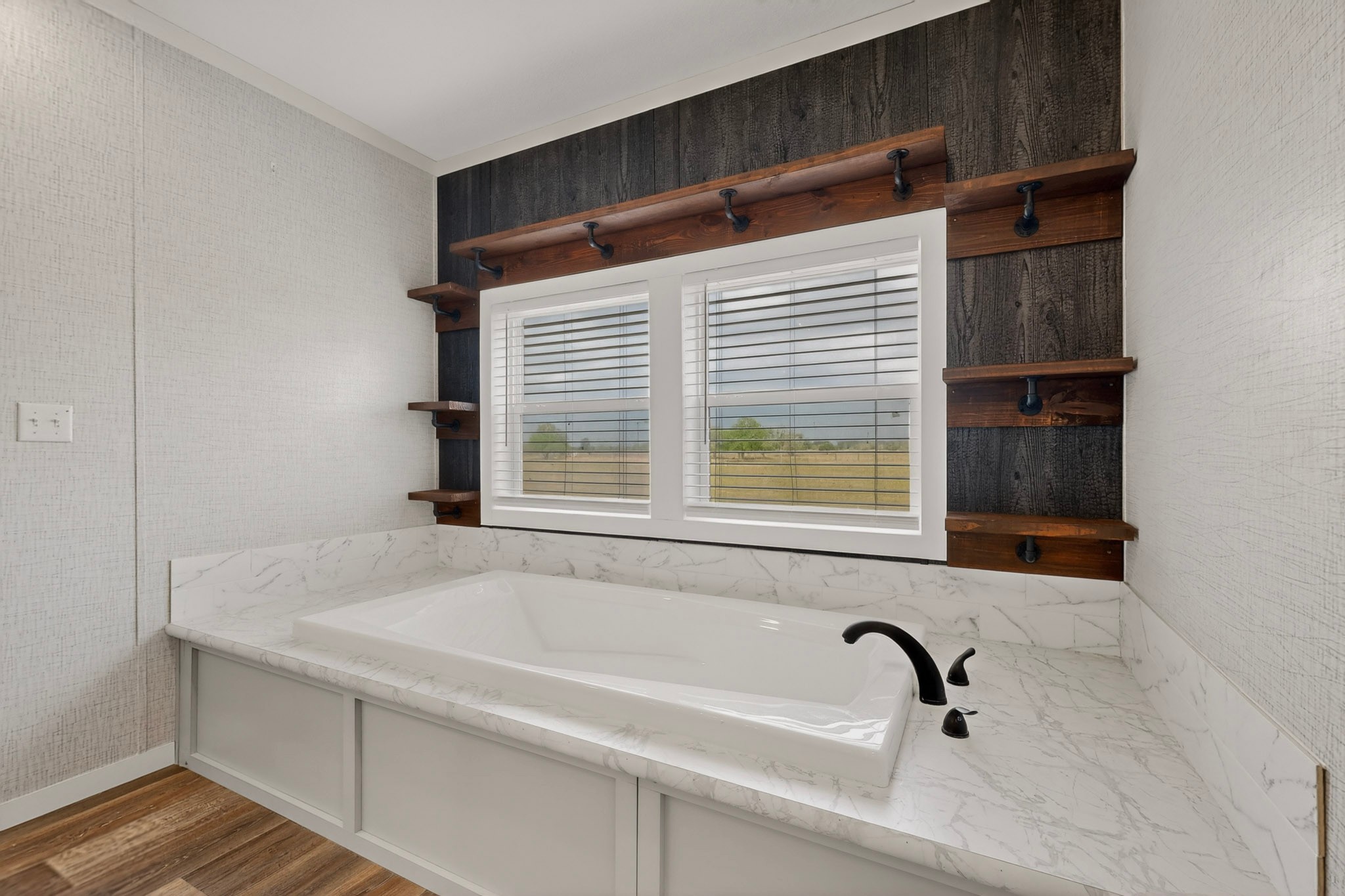 664 Garrett Road Yoakum, TX 77995 - Photo 10 of 39 Built-in soaking tub with a surrounding marbled countertop, complete with a matte black faucet