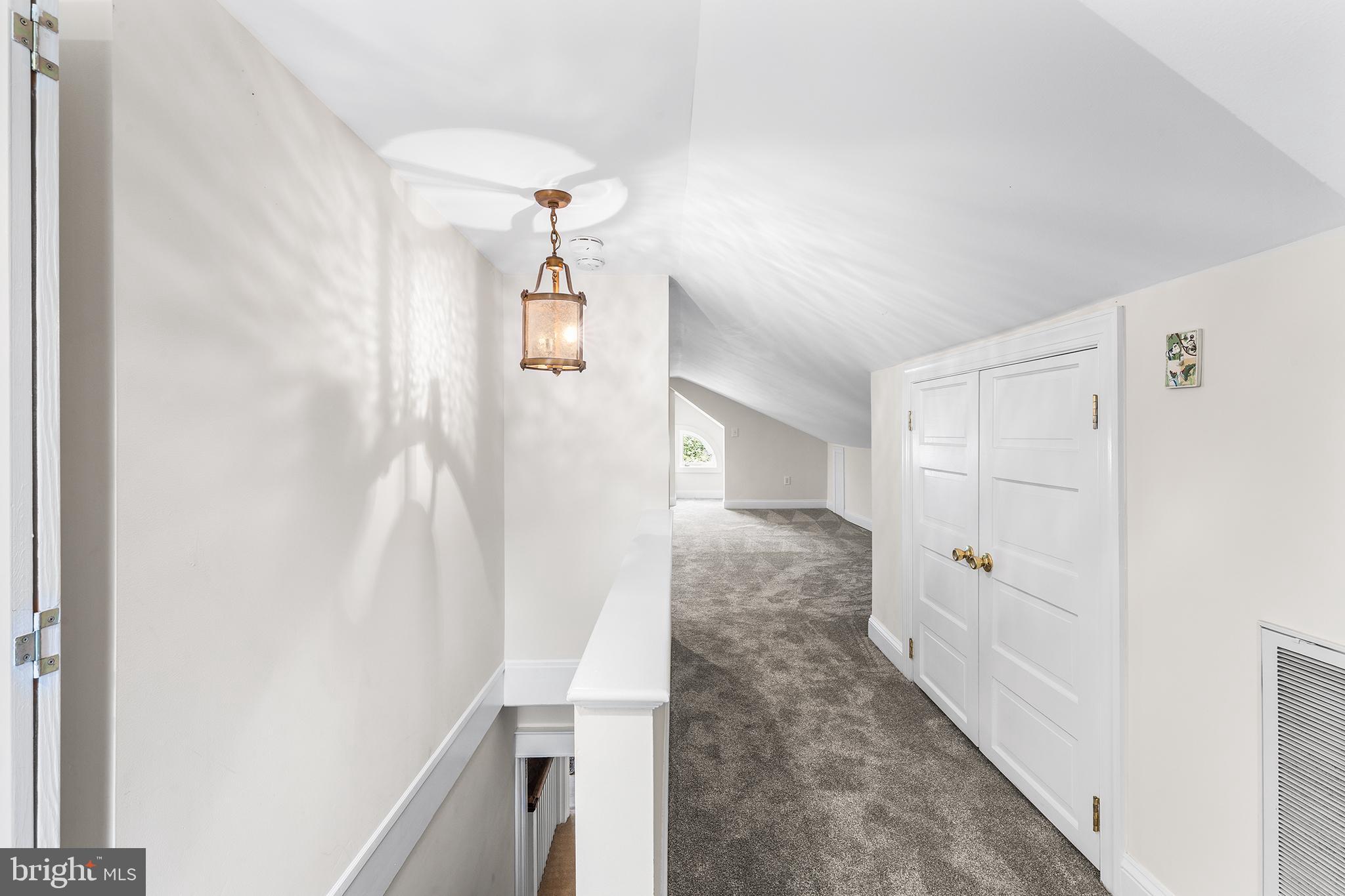 401 North Rolling Road Springfield, PA 19064 - Photo 36 of 79 a view of a hallway with white walls and stairs