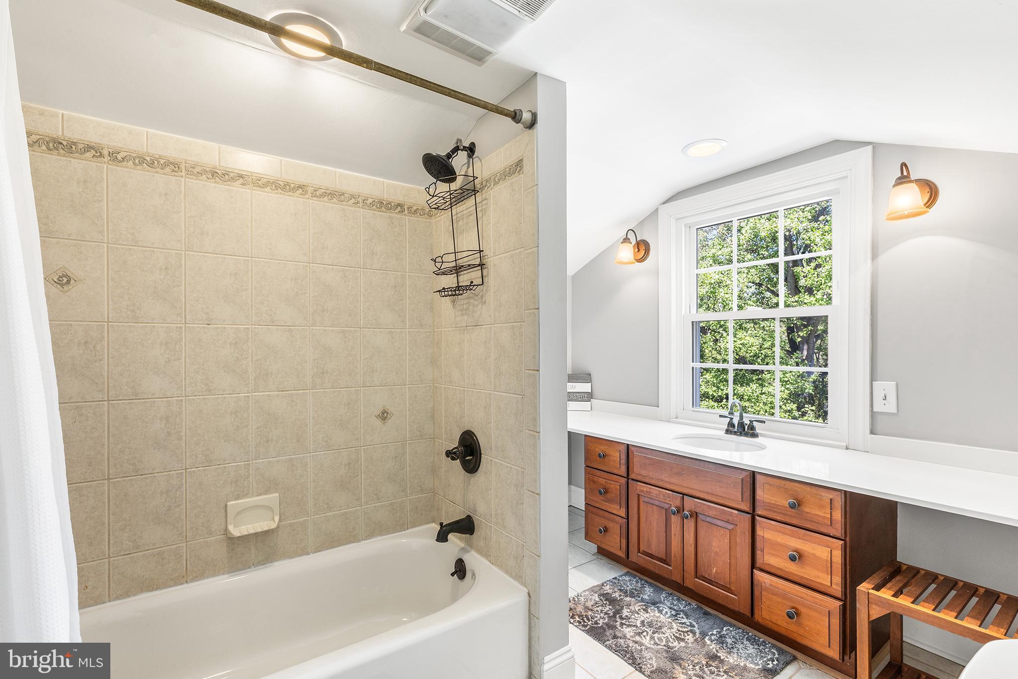 401 North Rolling Road Springfield, PA 19064 - Photo 40 of 79 a bathroom with a tub sink and mirror