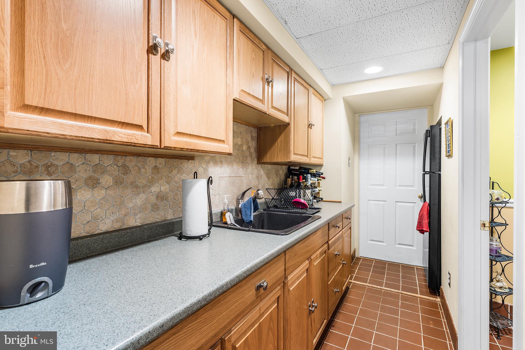 401 North Rolling Road Springfield, PA 19064 - Photo 44 of 79 a kitchen with sink a refrigerator and cabinets