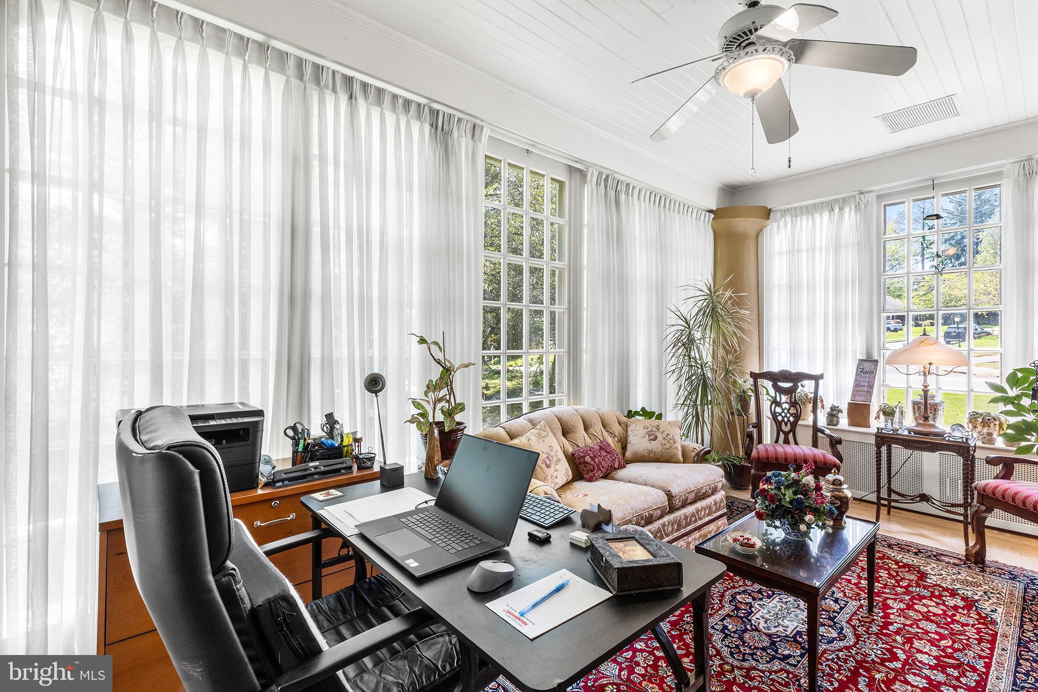 401 North Rolling Road Springfield, PA 19064 - Photo 8 of 79 a living room with furniture and floor to ceiling windows