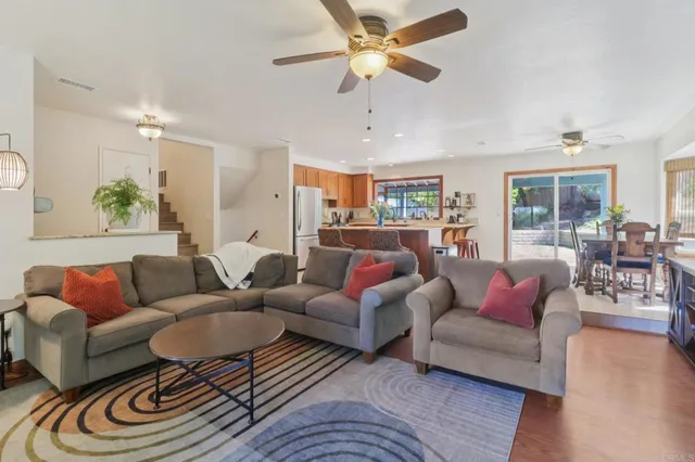 a living room with furniture ceiling fan and a rug