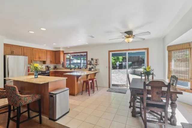 a dining room with furniture a chandelier and wooden floor