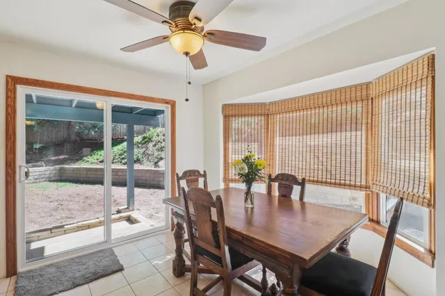 a kitchen with a table chairs refrigerator and microwave