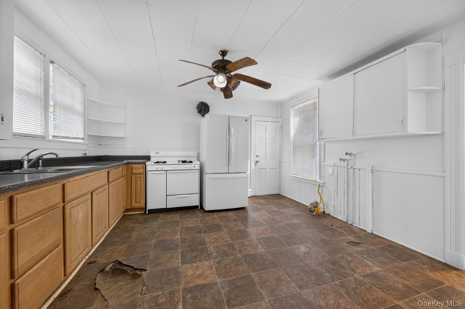 49 Cedar Street Babylon, NY 11702 - Photo 7 of 20 a utility room with cabinets and a sink