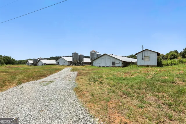a view of a house with a yard and lake view