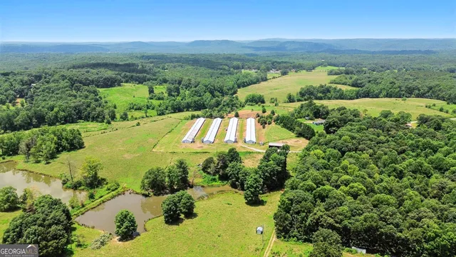 an aerial view of a houses with a yard