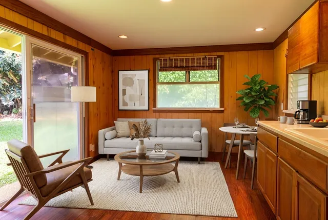 a bedroom with a large bed couch and a window